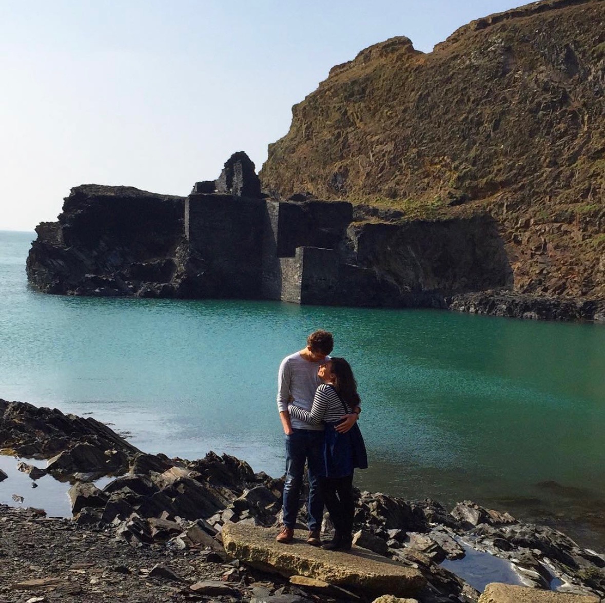Joe and Naomi stood cuddling in front of the blue lagoon.